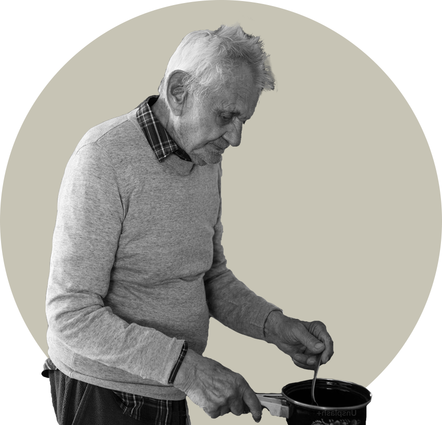 An older man cooking alone